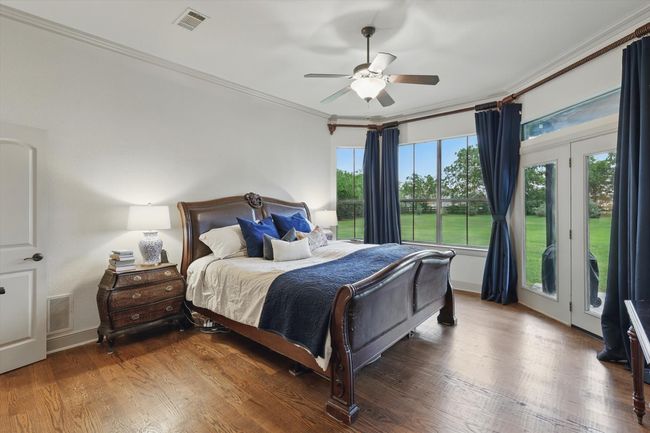 Bedroom featuring crown molding, access to outside, wood finished floors, and a ceiling fan | Image 18