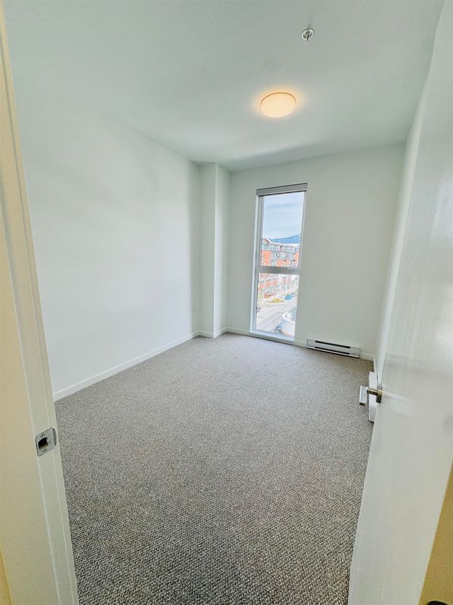 Carpeted spare room with baseboards and a baseboard heating unit | Image 12