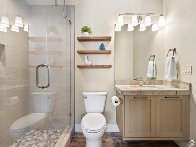 Full bath featuring toilet, vanity, and a stall shower | Image 24