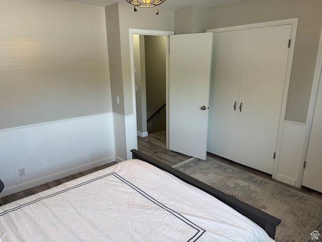 Bedroom with wainscoting and wood finished floors | Image 14