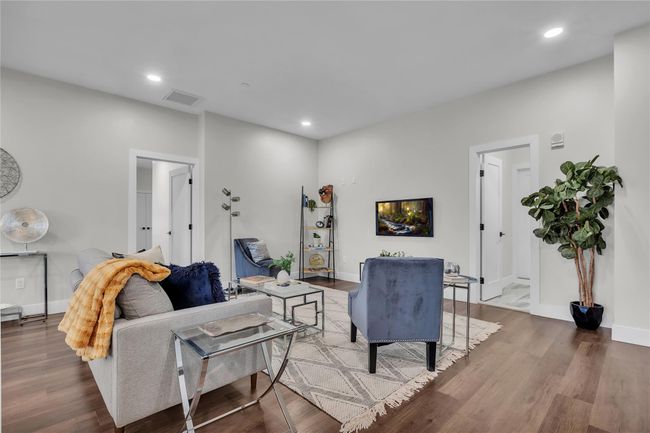 Living area with wood finished floors, baseboards, and recessed lighting | Image 5