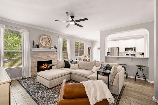Spacious living room with fireplace, open to the kitchen for easy entertaining | Image 7