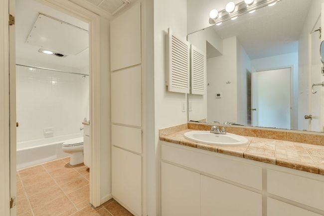 Primary bedroom has its own separate bathroom vanity with storage. | Image 20