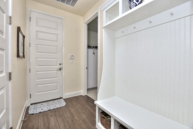 Mudroom with visible vents, baseboards, and dark wood finished floors | Image 28