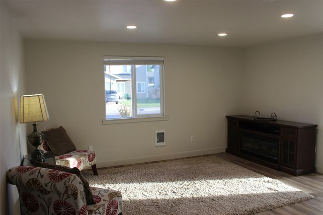 Living area with recessed lighting and wood finished floors | Image 5