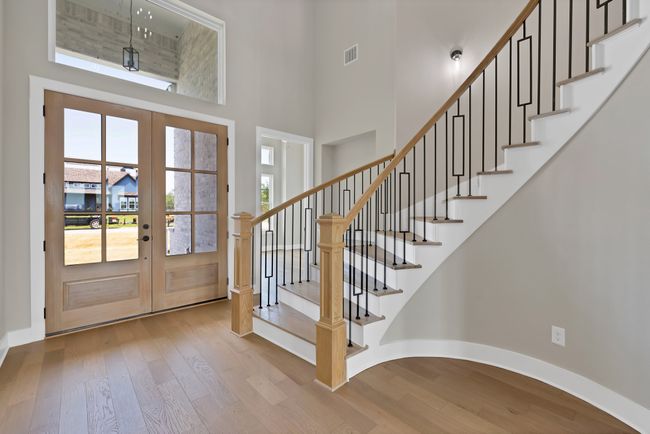 Foyer featuring french doors, hardwood / wood-style floors, stairs, and a towering ceiling | Image 4