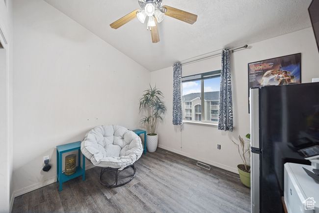 Sitting room featuring a textured ceiling, wood finished floors, visible vents, and baseboards | Image 19