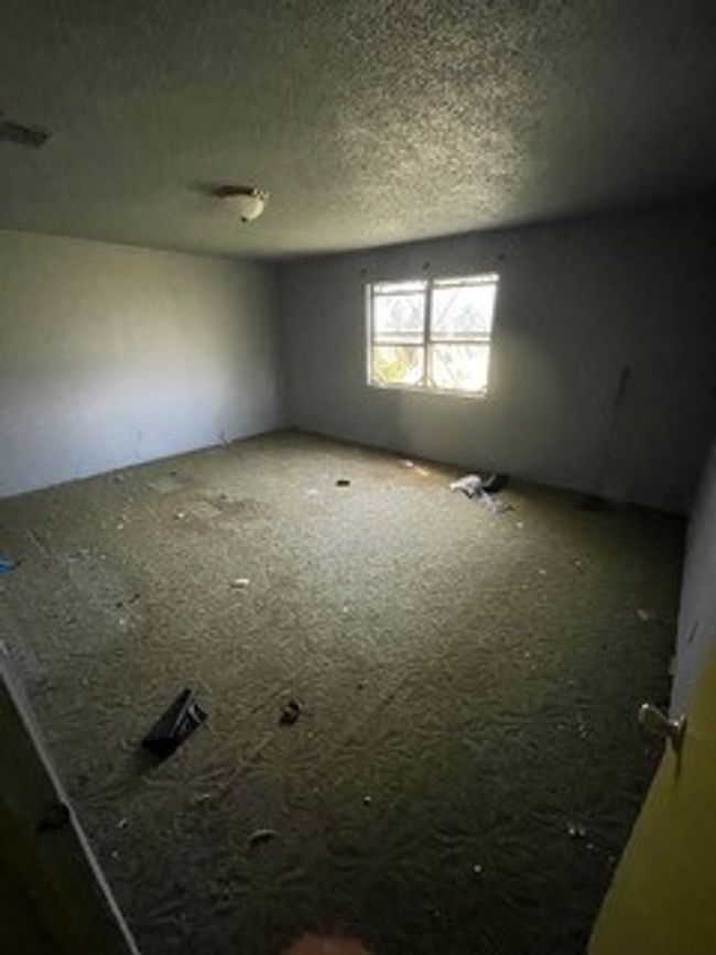 Empty room featuring a textured ceiling | Image 26