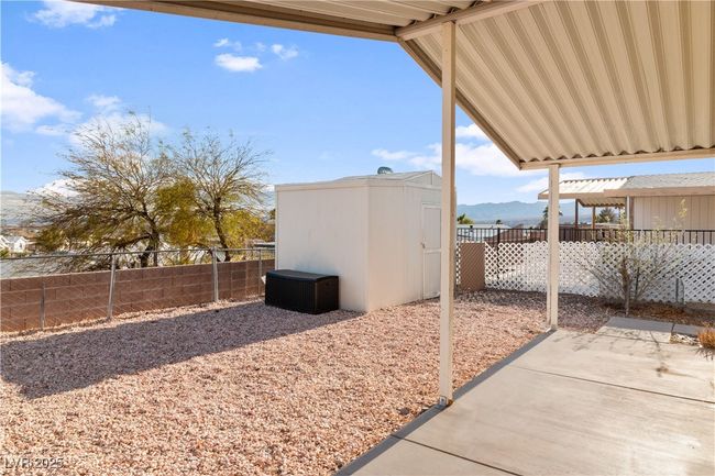 View of patio / terrace featuring an outbuilding, a storage unit, a fenced backyard, and a mountain view | Image 34