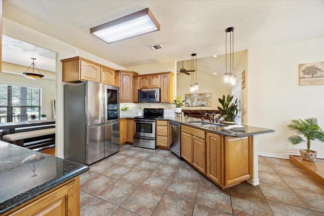 The perfect triangle for the cook in this kitchen plus it has lots of cabinet and counter space. | Image 16