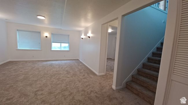 Carpeted spare room with stairway and baseboards | Image 24