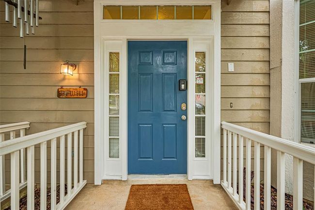 Beautiful blue door and porch warms your entry. | Image 5