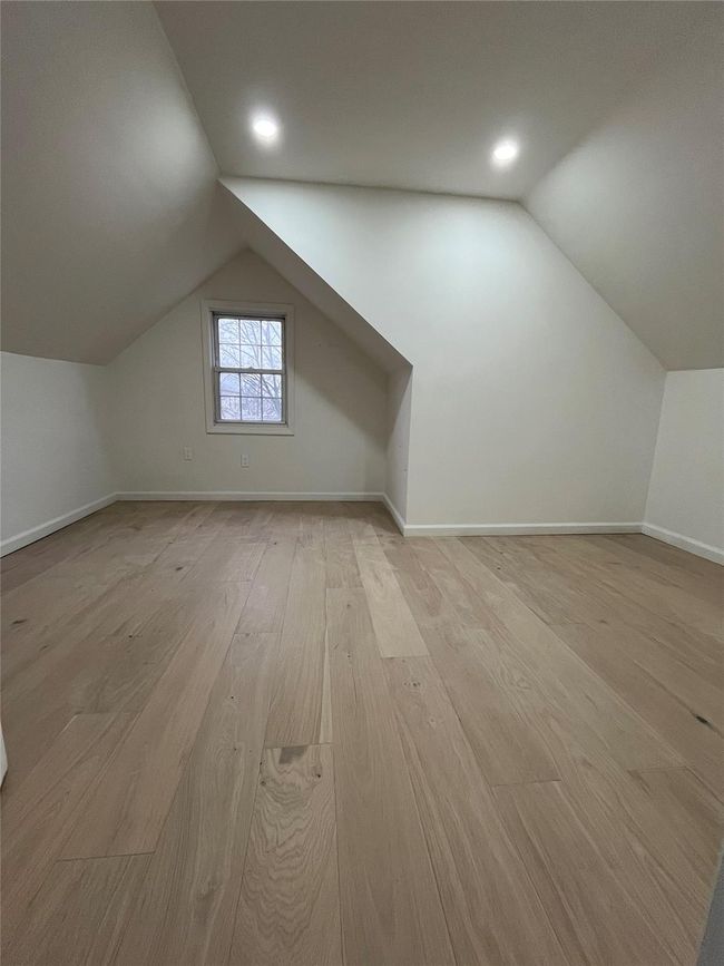 Additional living space with baseboards, vaulted ceiling, and light wood-style floors | Image 5