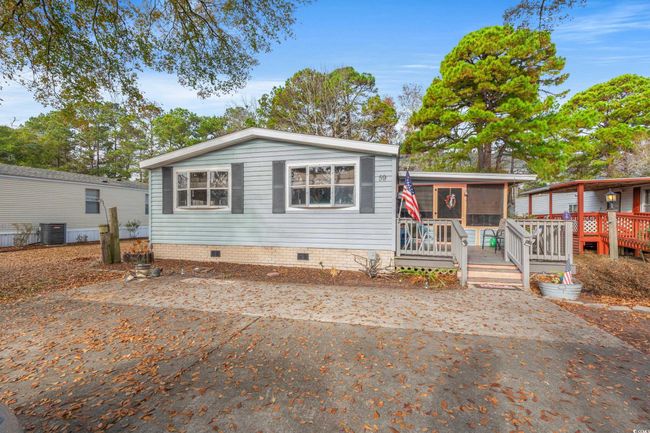 Manufactured / mobile home with a wooden deck, cooling unit, and a sunroom | Image 34