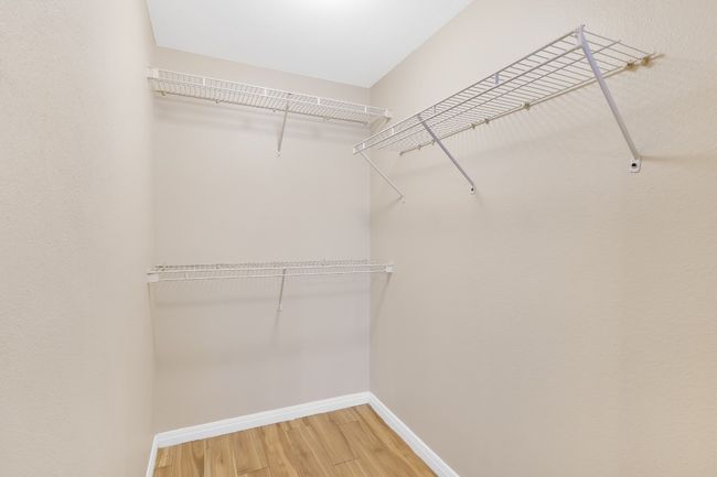 Walk in closet featuring wood finished floors. All new paint. | Image 13