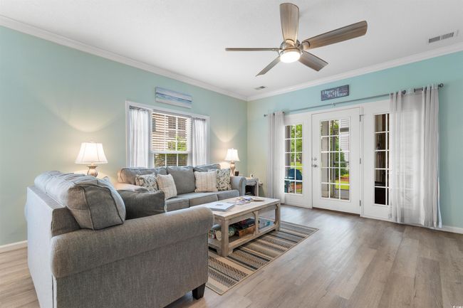 Living room featuring healthy amount of natural light, ornamental molding, and wood finished floors | Image 13
