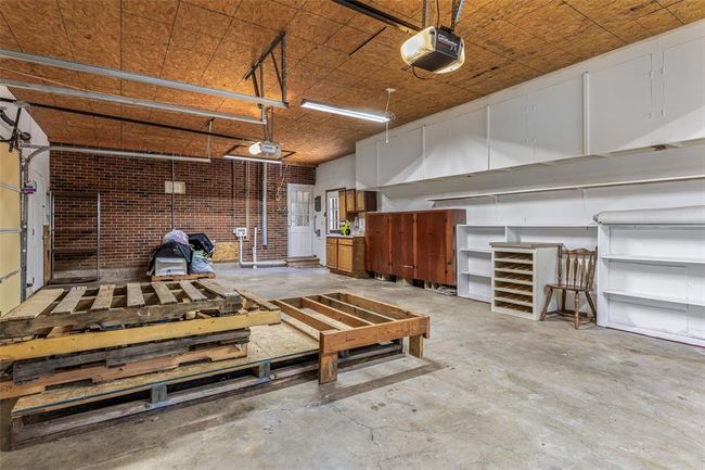 Garage featuring a garage door opener | Image 62