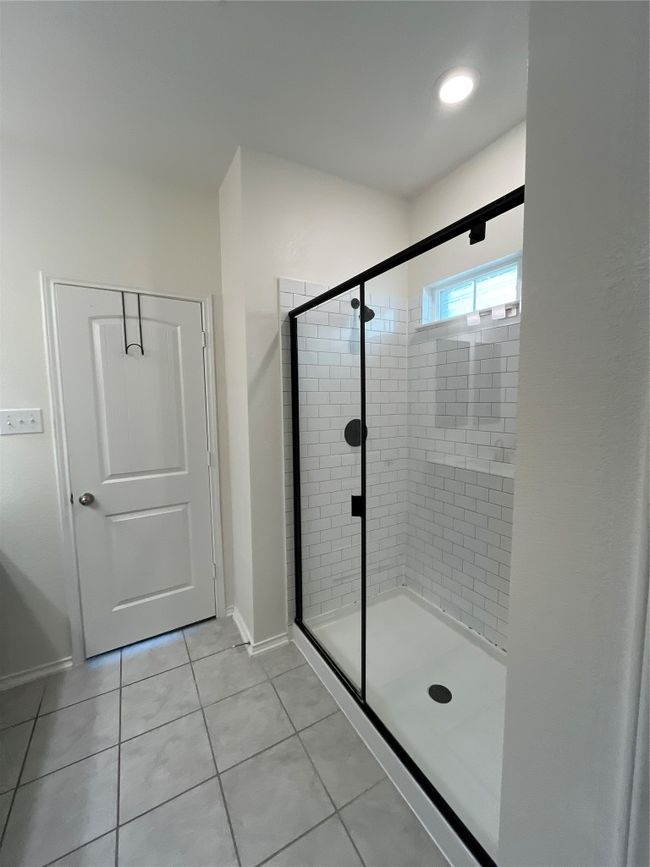 Full bathroom with baseboards, tile patterned flooring, and a shower stall | Image 16