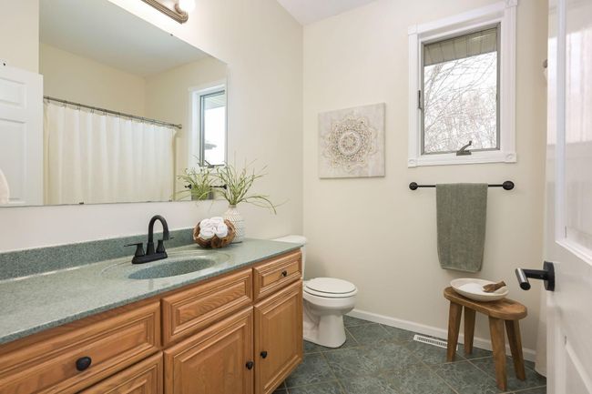 Main level full bath has updated sink faucet and oil rubbed bronze accents. | Image 27