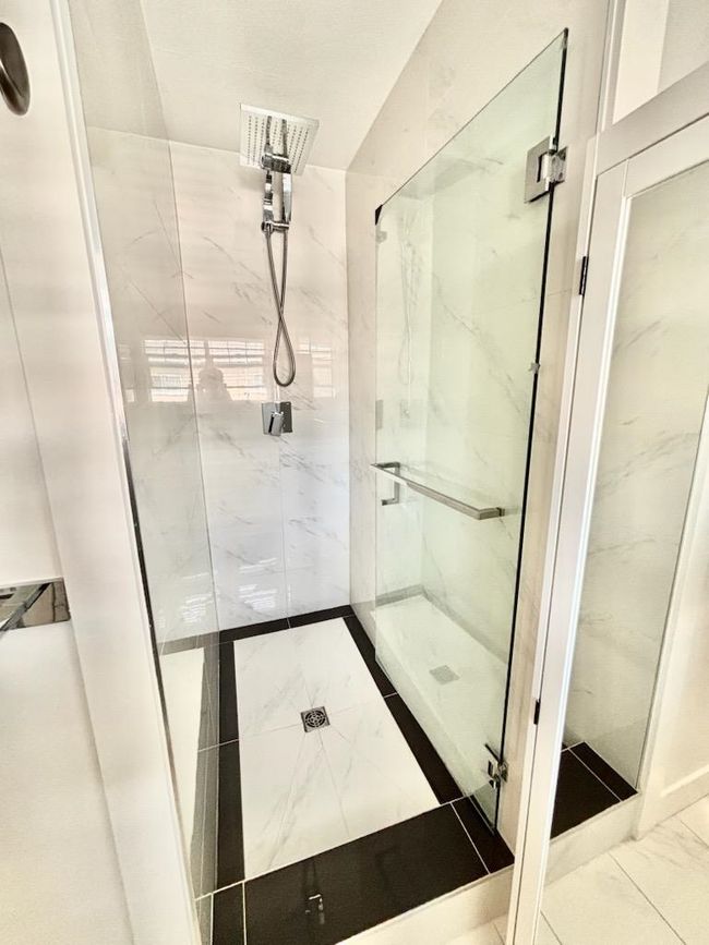 Full bath with marble finish floors and a marble finish shower | Image 19