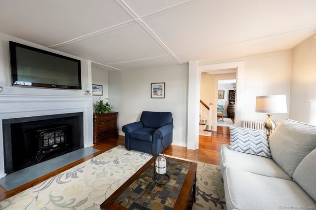 The fireplace has electric inserts, maintaining ambiance without upkeep | Image 5