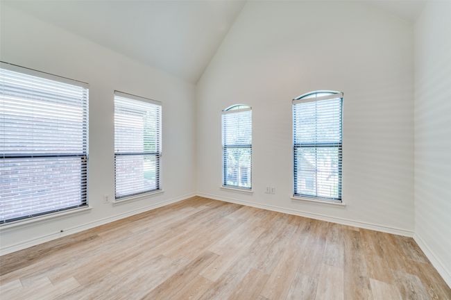This bright secondary bedroom features light laminate flooring that adds a modern, airy touch. A generously sized window fills the space with natural light, creating a warm and welcoming atmosphere. Ideal as a guest room, home office, or personal retreat. | Image 14