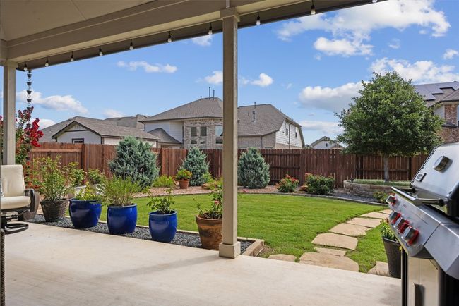 Enjoy the covered patio and beautifully landscaped yard | Image 26