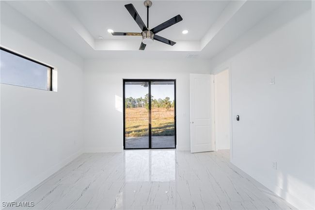 Empty room with a raised ceiling and ceiling fan | Image 14
