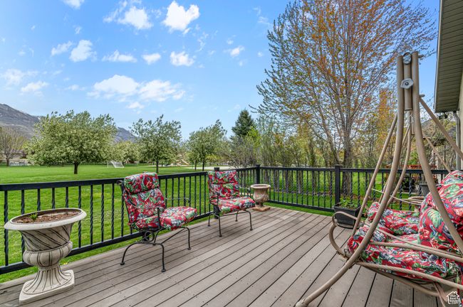 Deck with a mountain view and a lawn | Image 23
