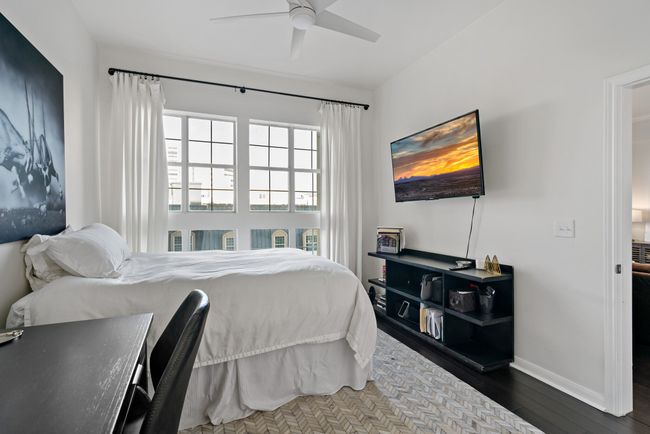 Bedroom with baseboards, ceiling fan, and dark wood-style floors | Image 17