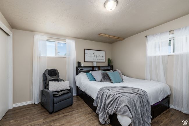 Bedroom with wood finished floors and baseboards | Image 12