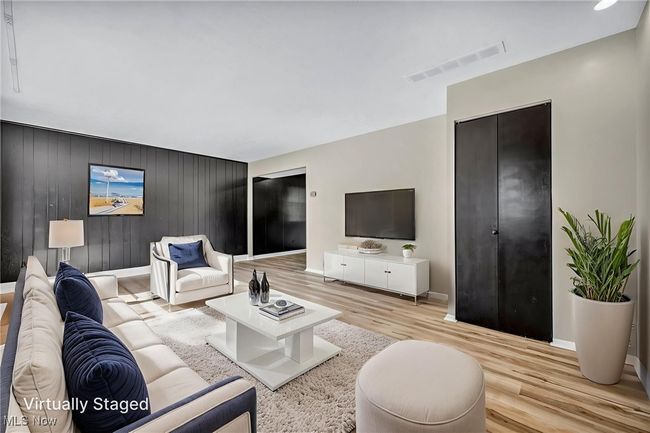 Living area with baseboards and light wood-style floors | Image 24