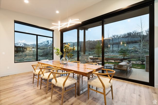 Dining room with baseboards, wood finished floors, recessed lighting, and an inviting chandelier | Image 28