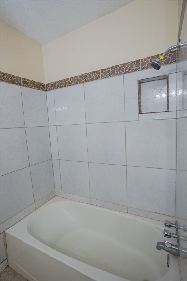 Bathroom 2 another view with a tub and tile walls | Image 16