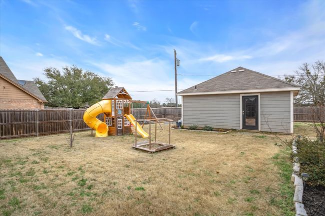 View of play area featuring a fenced backyard and a yard | Image 31