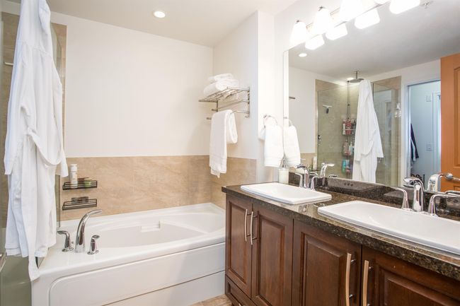 Full bathroom with double vanity, a bath, a stall shower, and a sink | Image 19