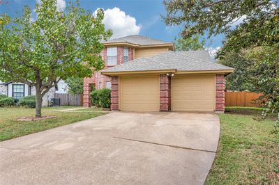 View of front of house with central AC unit and a front yard | Image 1