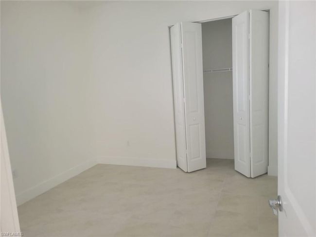 Unfurnished bedroom featuring baseboards and a closet | Image 23