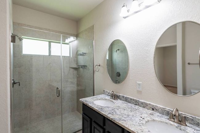 Bathroom featuring walk-in glass shower. | Image 24