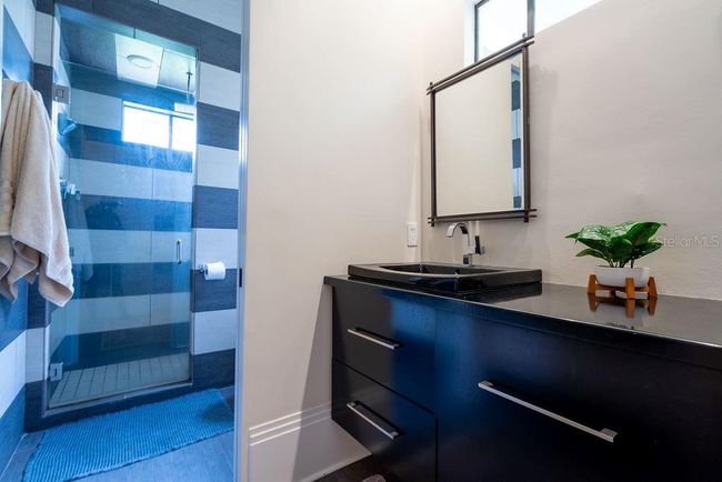 The second primary bedroom is privately located on the opposite side of the home, featuring double steel French doors that open directly onto the front porch, a great place to enjoy the sunrise. | Image 38