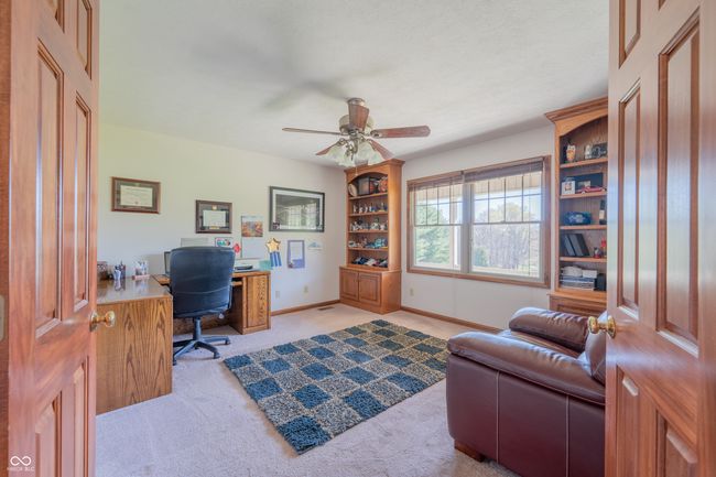 home office with light carpet, baseboards, and ceiling fan | Image 14