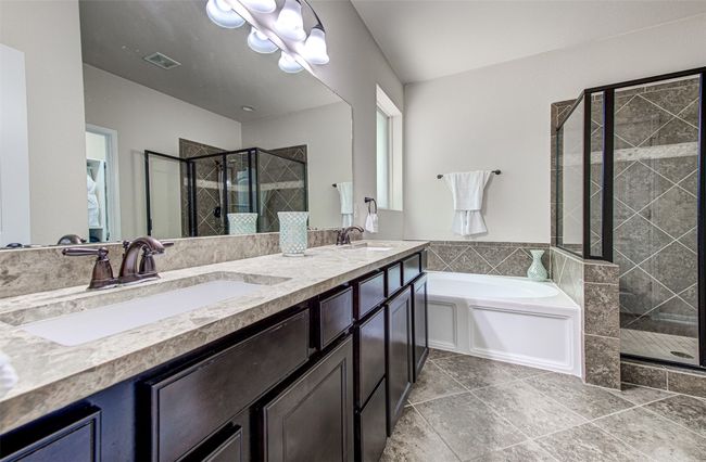 Primary Bath Retreat Boasts Dual Vanities, Relaxing Garden Tub, and Separate Shower for a Luxurious Spa-like Experience | Image 29