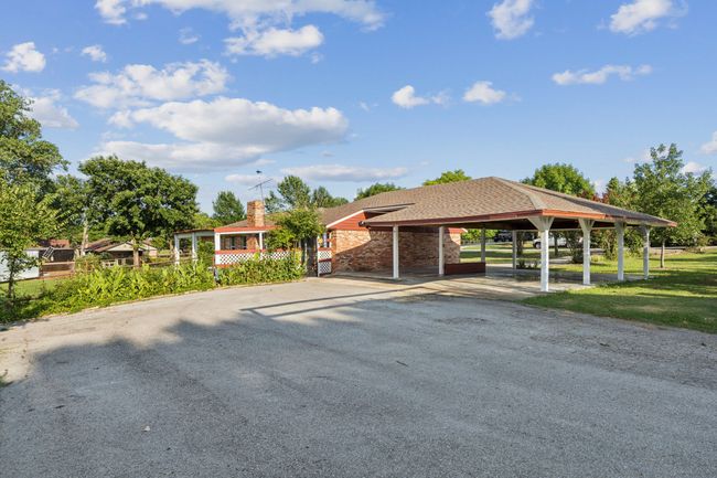 View of front of home featuring a carport, driveway, and a chimney | Image 32