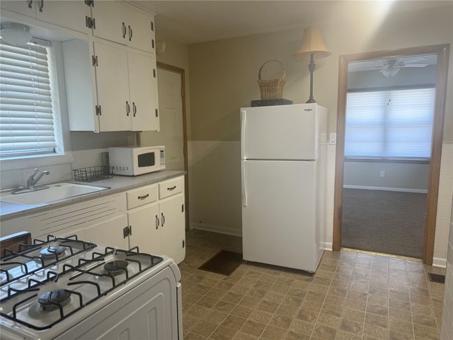 Unit A kitchen with view of living area. | Image 12