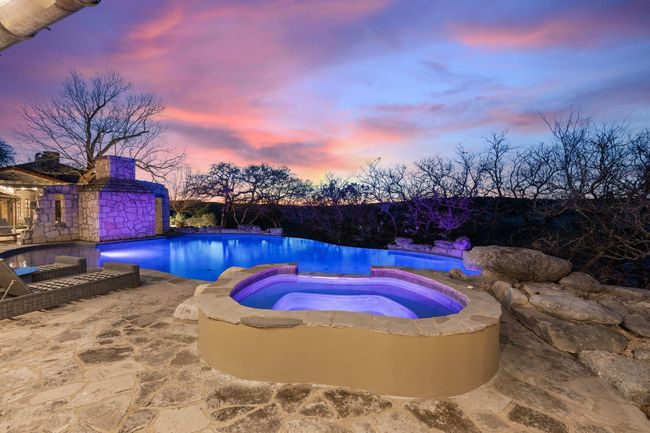 Pool at dusk with an outdoor pool and an in ground hot tub | Image 21