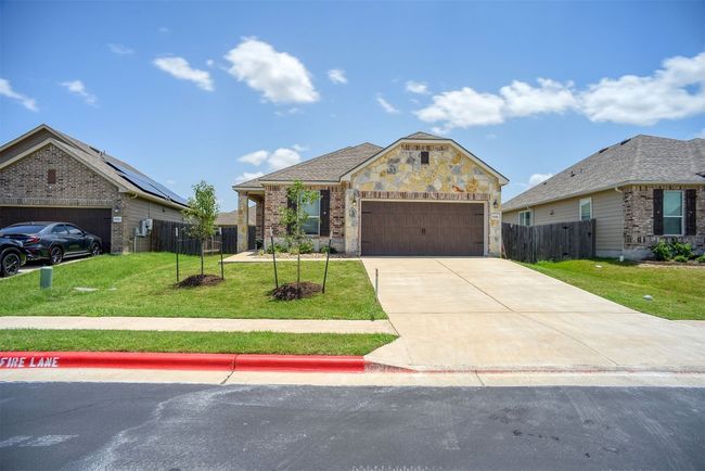 View of front of home featuring concrete driveway, an attached garage, and brick siding | Image 9