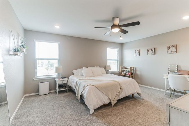Bedroom with light carpet and ceiling fan | Image 19