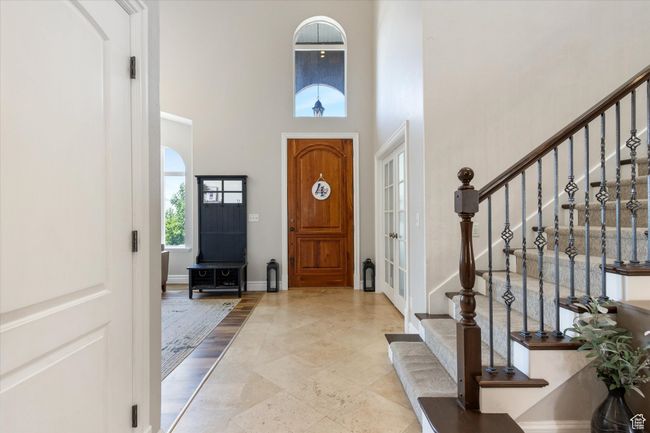 Entryway with a towering ceiling and custom flooring | Image 4