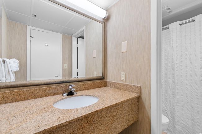 Full bathroom featuring vanity, toilet, wallpapered walls, and a shower with curtain | Image 23