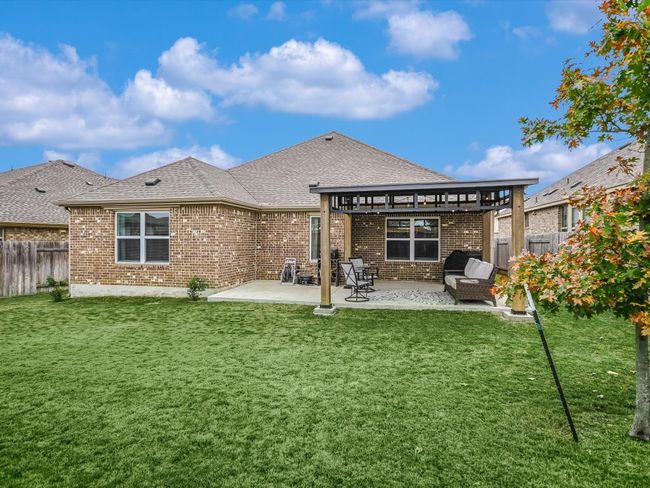 The lawn has been treated professionally - year round. There is an in-ground sprinkler system that covers the entire yard and a soaker hose in the front bed. Note the gutters and extended patio! 4 Sides Brick! These things matter to your insurance company! | Image 18